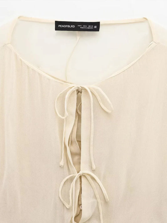 New spring women's clothing European and American style ruffled edge lace-up fake two-piece layered trumpet sleeve shirt.