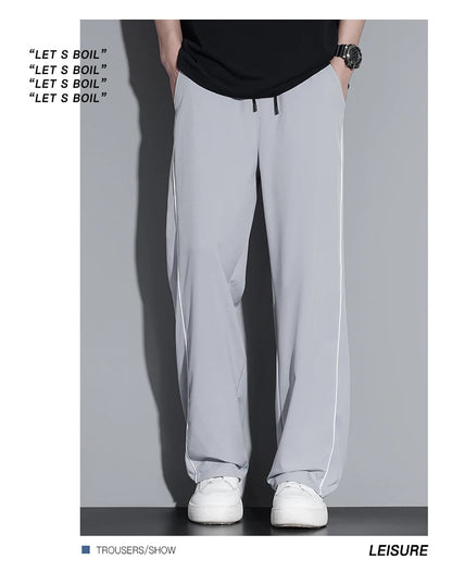 Summer ice silk thin section pants men's Hong Kong style loose splicing casual sports wide-legged pants elastic speed pants.