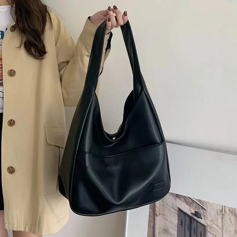 Large capacity tote bag, new black leather simple casual commuting women's bag, fashionable and versatile single shoulder bag.