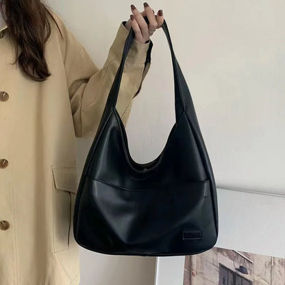 Large capacity tote bag, new black leather simple casual commuting women's bag, fashionable and versatile single shoulder bag.