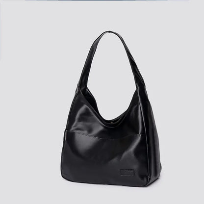 Large capacity tote bag, new black leather simple casual commuting women's bag, fashionable and versatile single shoulder bag.