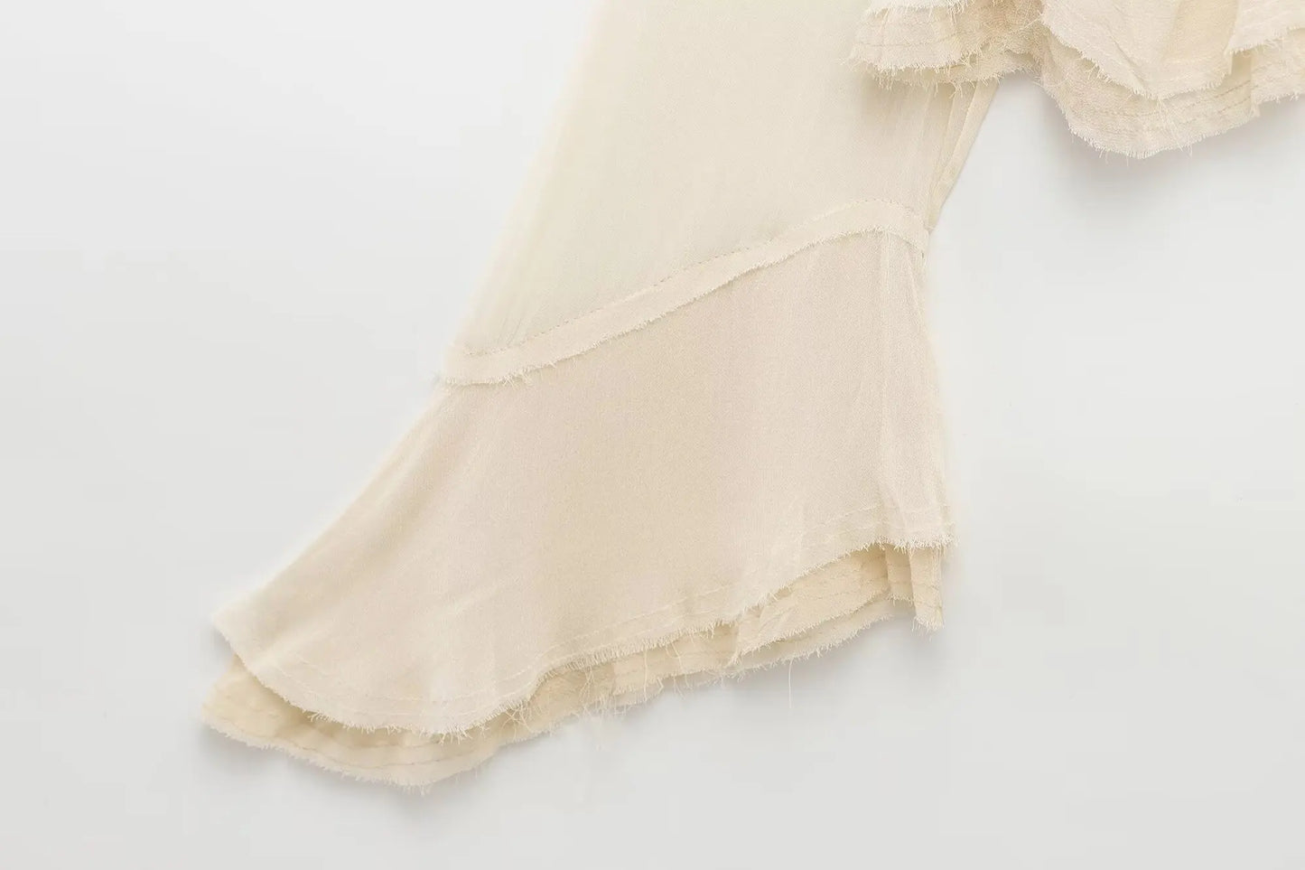 New spring women's clothing European and American style ruffled edge lace-up fake two-piece layered trumpet sleeve shirt.