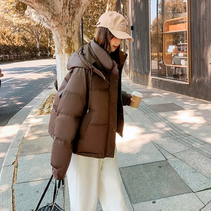 2024 Winter Neue frauen Unten Baumwolle Gefütterte Jacken Stilvolle Mit Kapuze Einfarbig Casual Verdicken Warme Lose anliegende kurze Mäntel.
