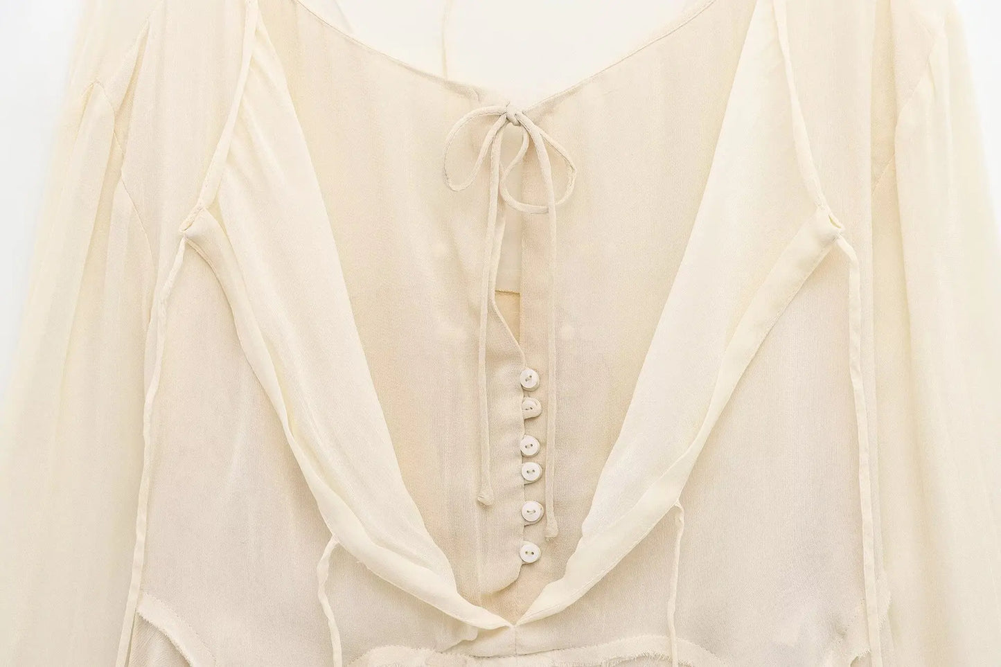 New spring women's clothing European and American style ruffled edge lace-up fake two-piece layered trumpet sleeve shirt.