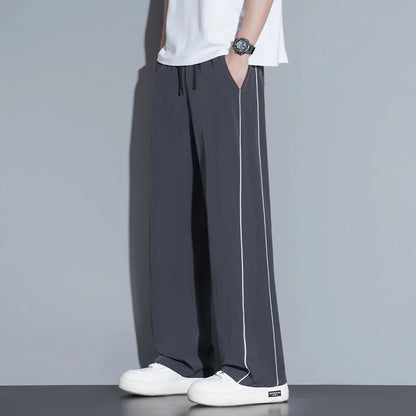 Summer ice silk thin section pants men's Hong Kong style loose splicing casual sports wide-legged pants elastic speed pants.