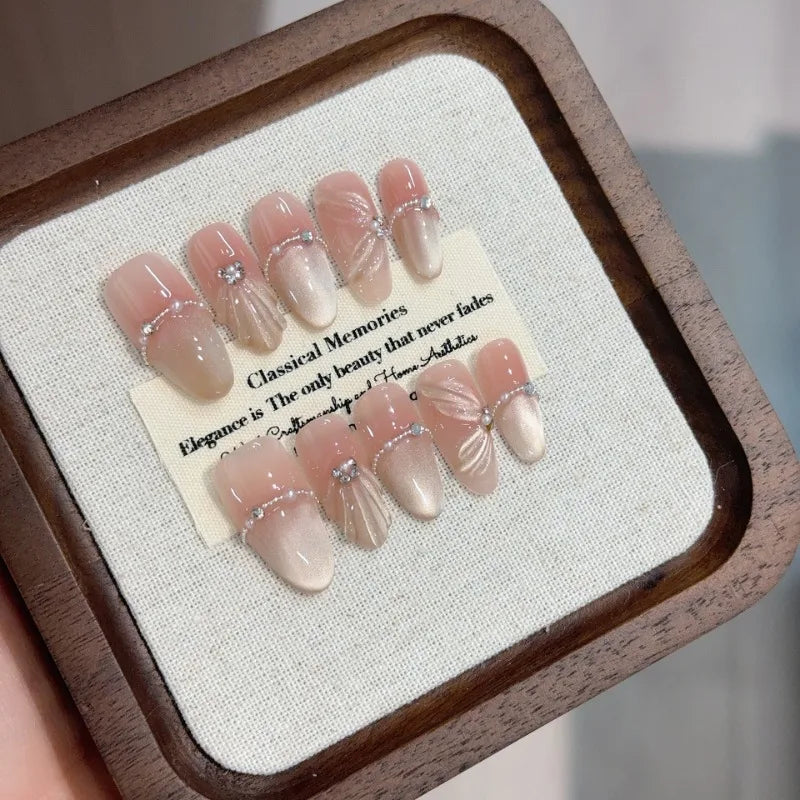 10Pcs mid-length oval White Moonlight Cat Eyes Nails Sliver Bowknot Press on False Nails with Pearl Diamond Full Cover Nail Tips.