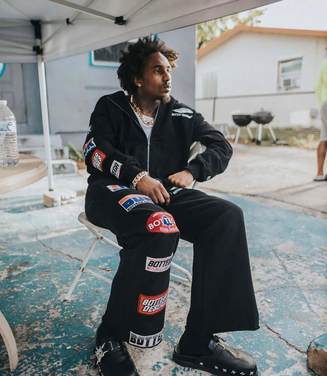 Black trendy patterned hip-hop sportswear set Y2K hooded zipper top with brand logo print and multiple badges streetwear fashion.