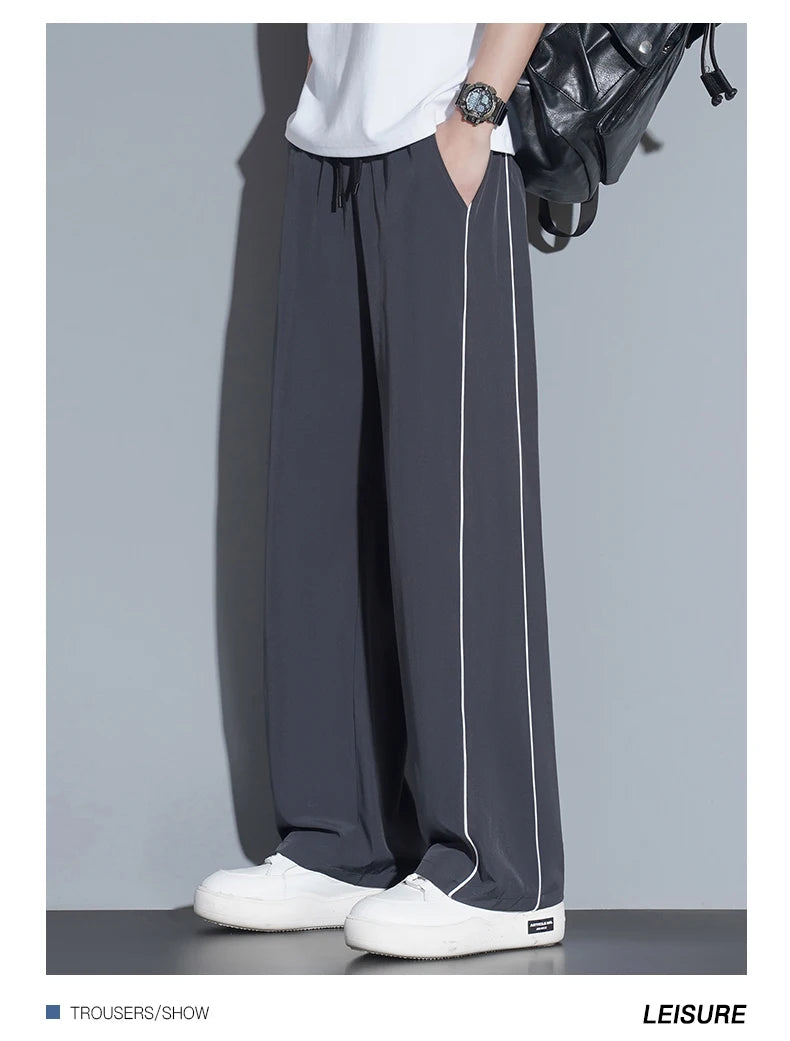 Summer ice silk thin section pants men's Hong Kong style loose splicing casual sports wide-legged pants elastic speed pants.