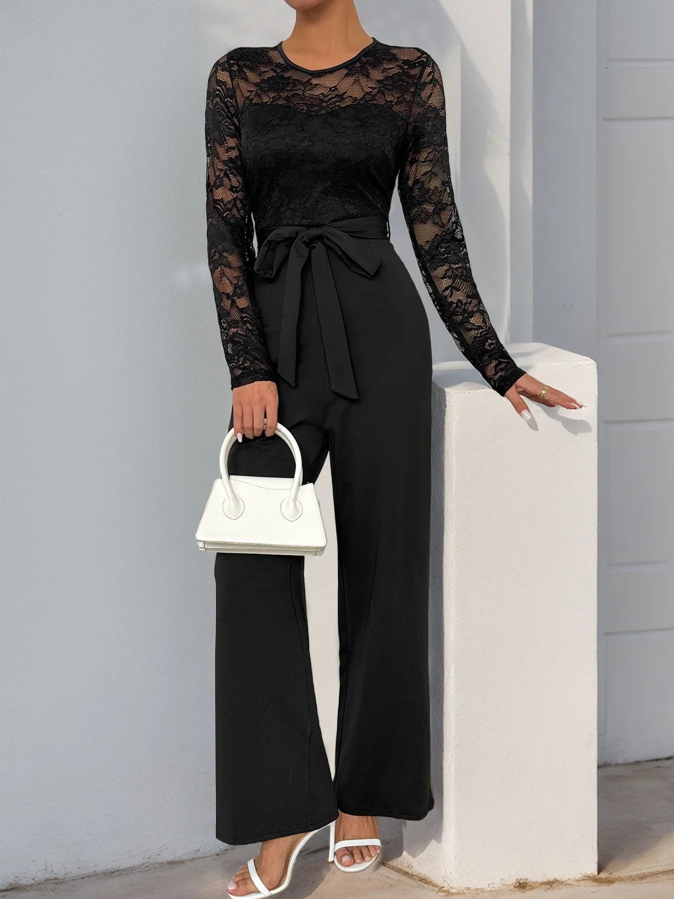 Woman Black Lace Sleeve Jumpsuit Round Neck Belted Waist Ideal for Evening Parties and Cocktail Events.