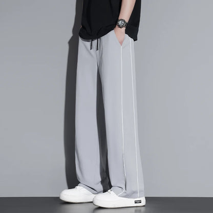 Summer ice silk thin section pants men's Hong Kong style loose splicing casual sports wide-legged pants elastic speed pants.