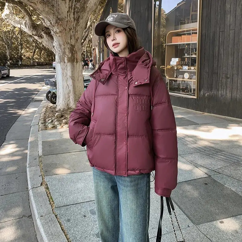 2024 Winter Neue frauen Unten Baumwolle Gefütterte Jacken Stilvolle Mit Kapuze Einfarbig Casual Verdicken Warme Lose anliegende kurze Mäntel