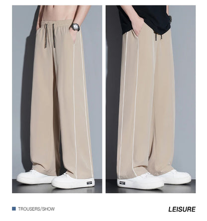 Summer ice silk thin section pants men's Hong Kong style loose splicing casual sports wide-legged pants elastic speed pants.