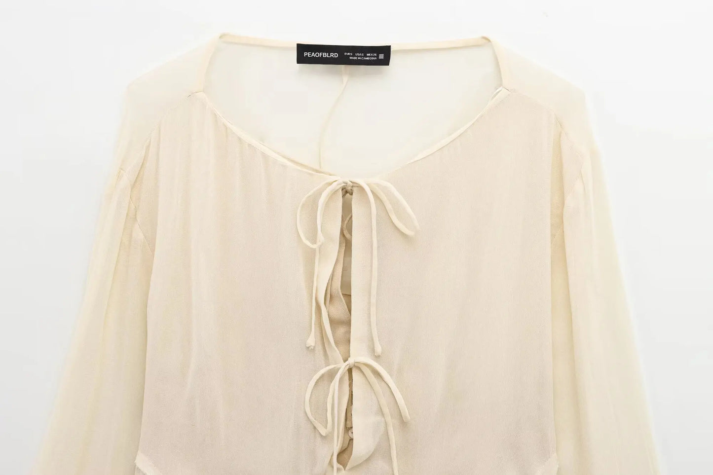 New spring women's clothing European and American style ruffled edge lace-up fake two-piece layered trumpet sleeve shirt.