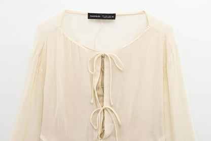 New spring women's clothing European and American style ruffled edge lace-up fake two-piece layered trumpet sleeve shirt.