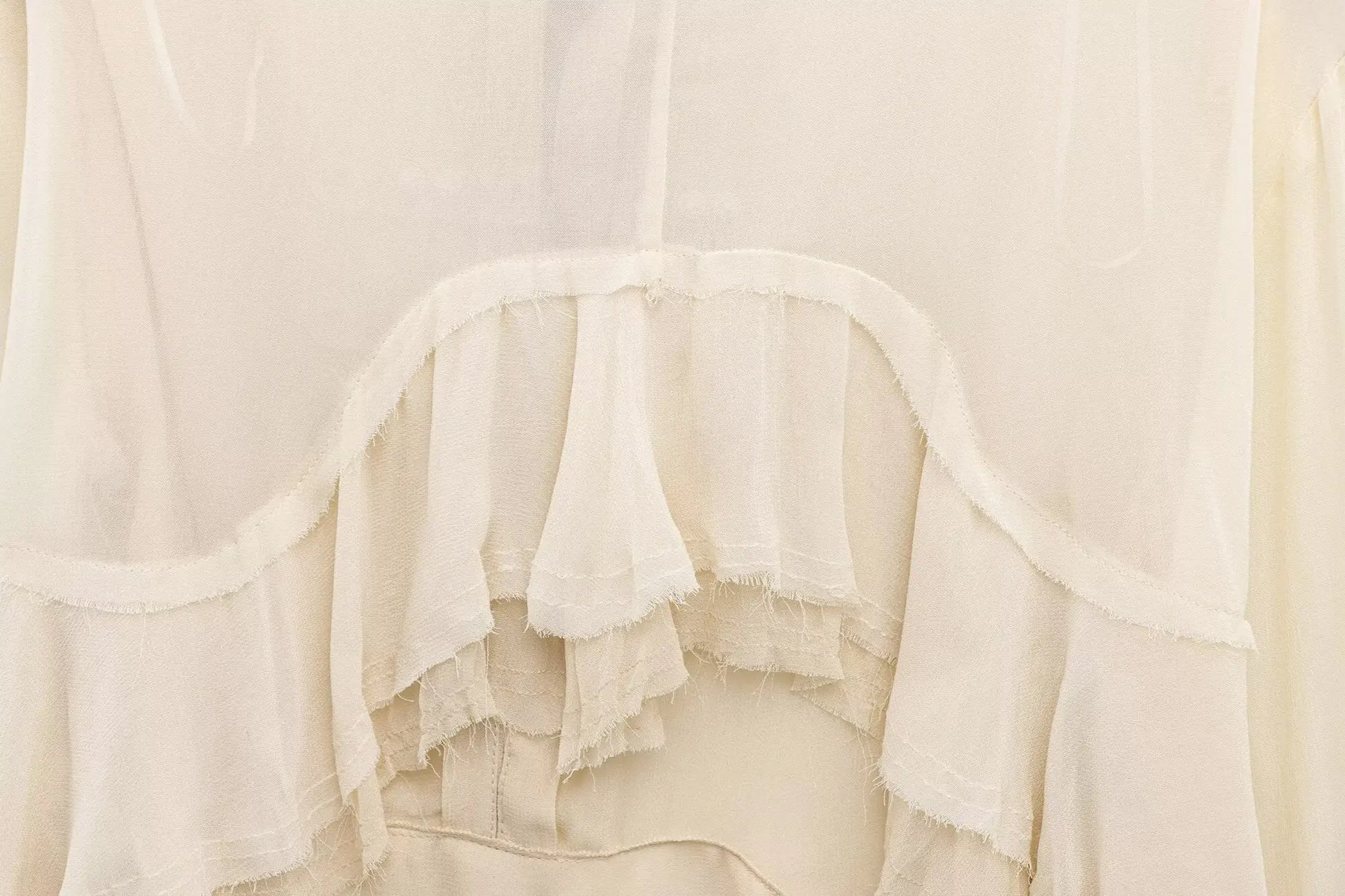 New spring women's clothing European and American style ruffled edge lace-up fake two-piece layered trumpet sleeve shirt.