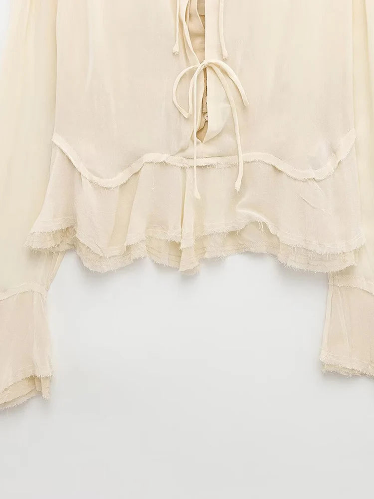 New spring women's clothing European and American style ruffled edge lace-up fake two-piece layered trumpet sleeve shirt.