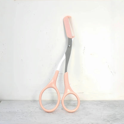 Pink eyebrow trimming scissors with built-in comb - stainless steel, precise grooming tool, creating perfect eyebrows.