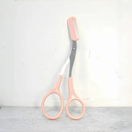 Pink eyebrow trimming scissors with built-in comb - stainless steel, precise grooming tool, creating perfect eyebrows.