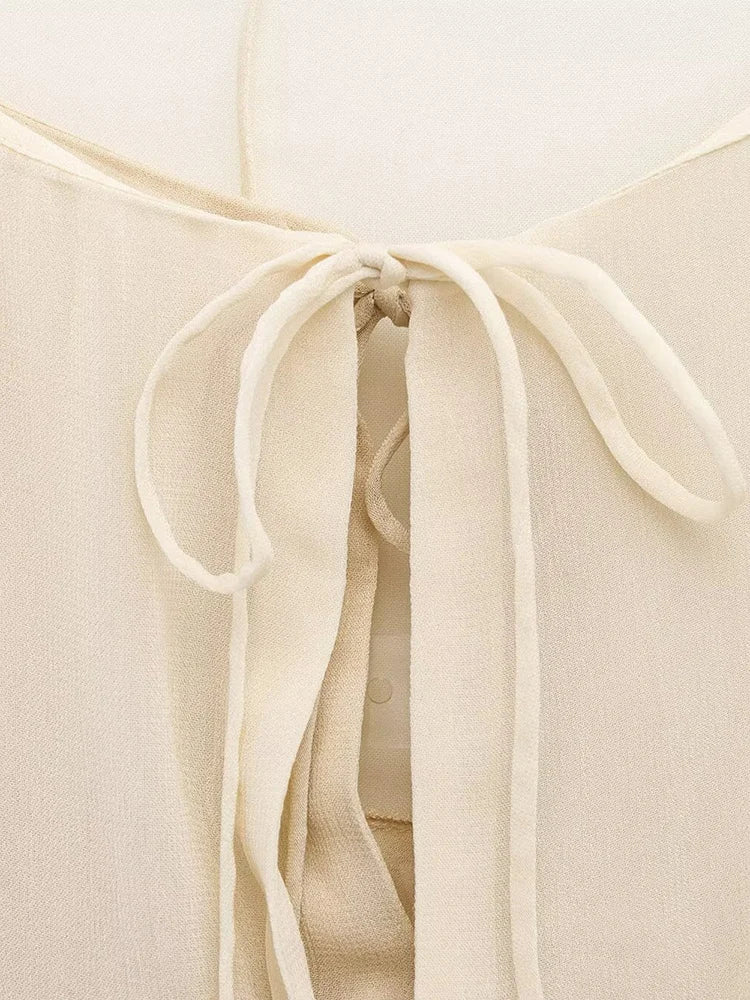 New spring women's clothing European and American style ruffled edge lace-up fake two-piece layered trumpet sleeve shirt.