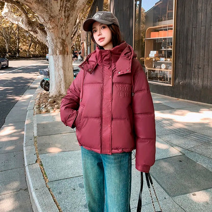 2024 Winter Neue frauen Unten Baumwolle Gefütterte Jacken Stilvolle Mit Kapuze Einfarbig Casual Verdicken Warme Lose anliegende kurze Mäntel