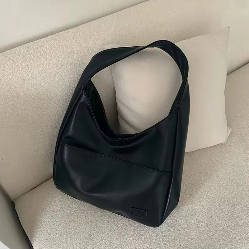 Large capacity tote bag, new black leather simple casual commuting women's bag, fashionable and versatile single shoulder bag.