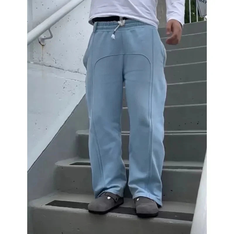 Casual Elastic Drawstring Zipper Pants High Street Hip Hop Streetwear Loose Fit Men's Trousers for Casual Scenarios.