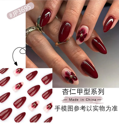 24pcs Women'S Nail Set Burgundy Almond Shape Medium Length Solid Color with Floral Golden Dust Design Fake Nails for Women/Girls.