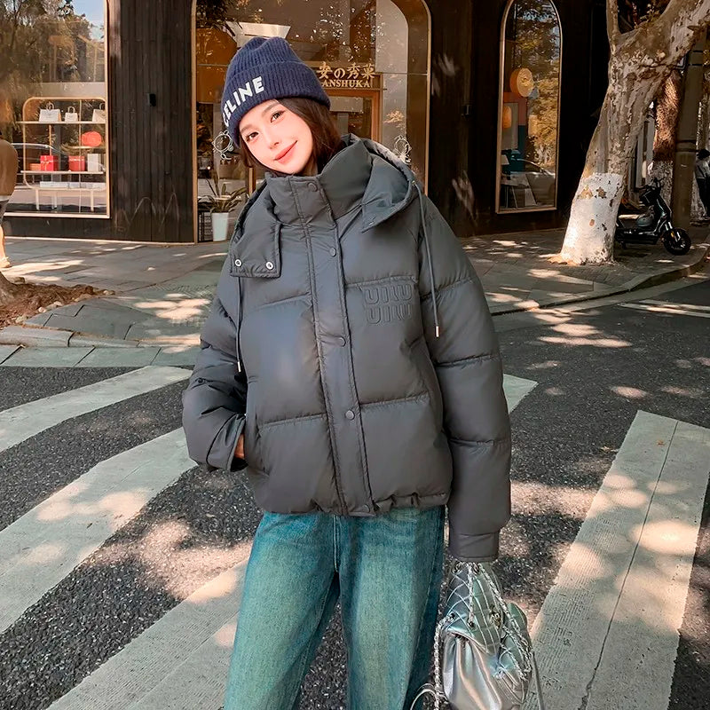 2024 Winter Neue frauen Unten Baumwolle Gefütterte Jacken Stilvolle Mit Kapuze Einfarbig Casual Verdicken Warme Lose anliegende kurze Mäntel.