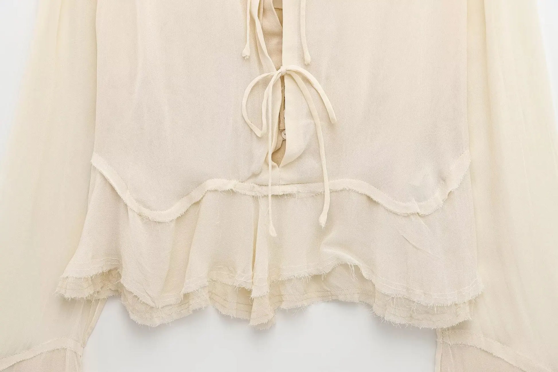 New spring women's clothing European and American style ruffled edge lace-up fake two-piece layered trumpet sleeve shirt.