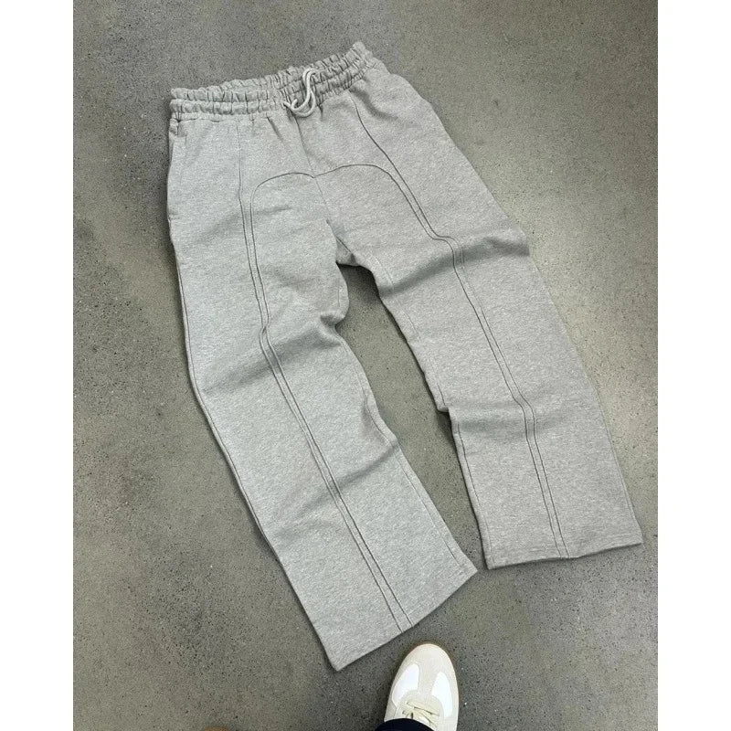 Casual Elastic Drawstring Zipper Pants High Street Hip Hop Streetwear Loose Fit Men's Trousers for Casual Scenarios.