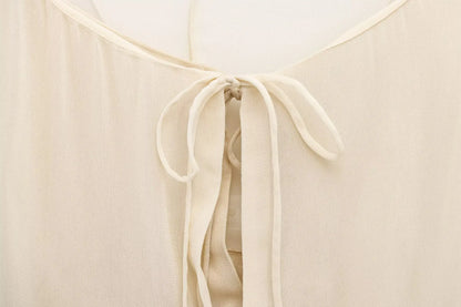 New spring women's clothing European and American style ruffled edge lace-up fake two-piece layered trumpet sleeve shirt.