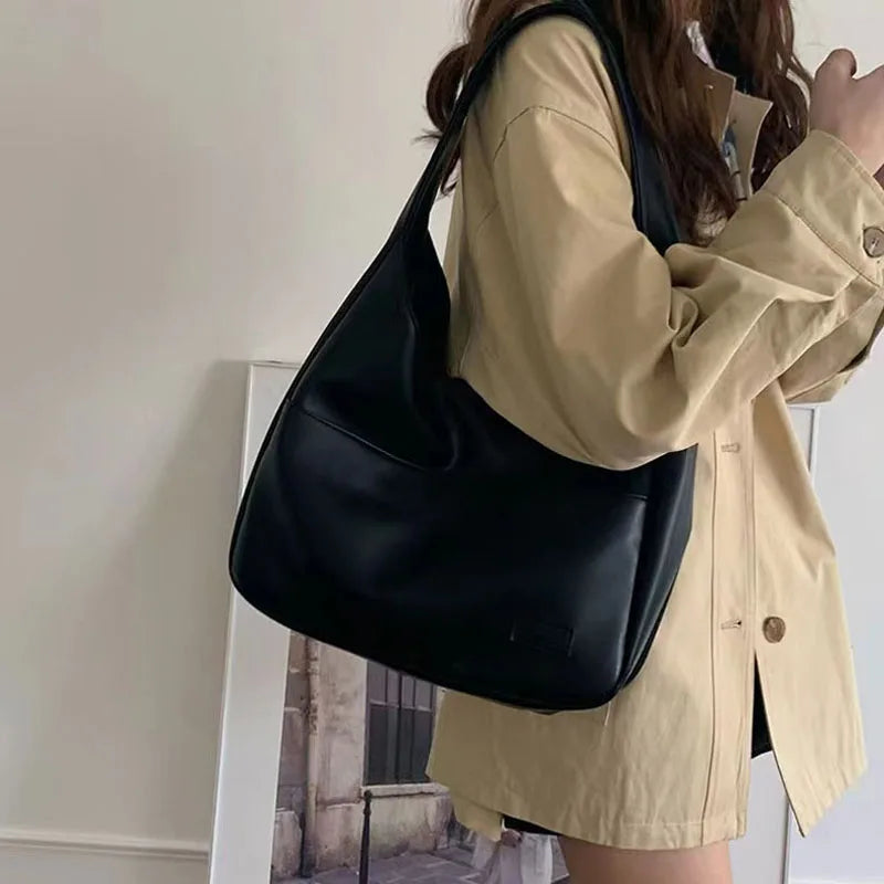 Large capacity tote bag, new black leather simple casual commuting women's bag, fashionable and versatile single shoulder bag.