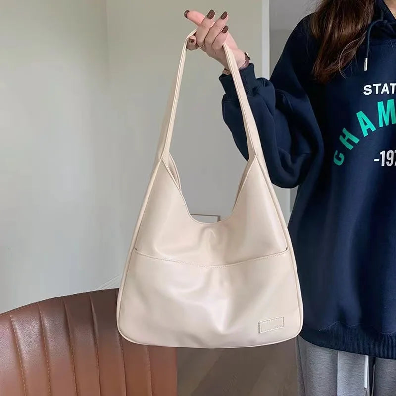 Large capacity tote bag, new black leather simple casual commuting women's bag, fashionable and versatile single shoulder bag.