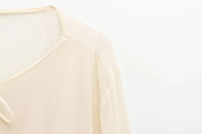 New spring women's clothing European and American style ruffled edge lace-up fake two-piece layered trumpet sleeve shirt.